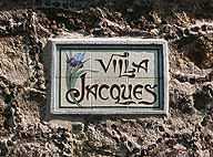 Détail de la plaque en céramique portant l'inscription ""Villa Jacques"" sur la façade latérale.