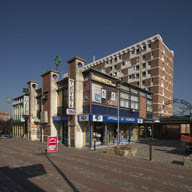 Le bâtiment principal R+1 du centre commercial de la Patte d'Oie ; à l'arrière plan, l'immeuble R+9 des Briques Rouges.