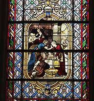 Détail : médaillon du bas naissance de saint Roch (baie 3).